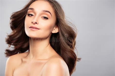 brunette girl with healthy curly hair and natural make up beautiful model woman with wavy
