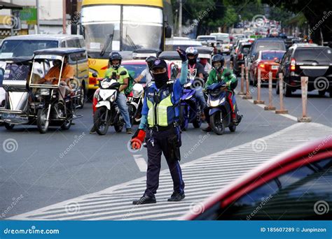 Traffic Officers Direct And Manage The Flow Of Traffic At A Busy Rotonda Or Roundabout Road