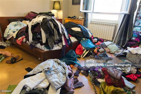 Messy Bedroom With Clothes And Possessions Thrown Around High Res Stock