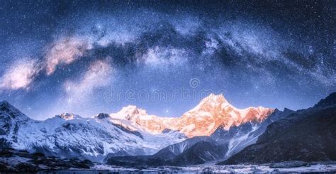 Milky Way Arch Over Snowy Mountains At Starry Night In Winter Stock