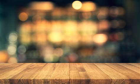 Wood Texture Table Top With Blur Light Gold Bokeh In Caferestaurant