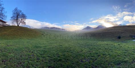 A Green Grassland In The Mountains During The Dawn Stock Photo Image