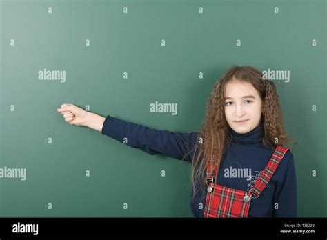 Schoolgirl Near Green School Board Young Playful Girl Shows Finger High Resolution Photo Stock