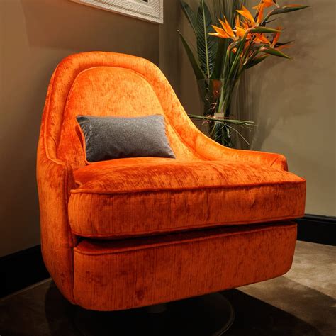 This swivel armchair will bring back the spirit of the 80's to your home! Contemporary Orange Velvet Swivel Armchair