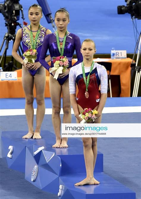 Chinese Gymnasts Yao Jinnan C And Huang Huidan L Russian Gymnast Daria Spiridonova Pose On