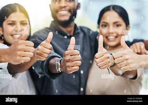 Shot Of A Group Of Businesspeople Together Giving The Thumbs Up Stock