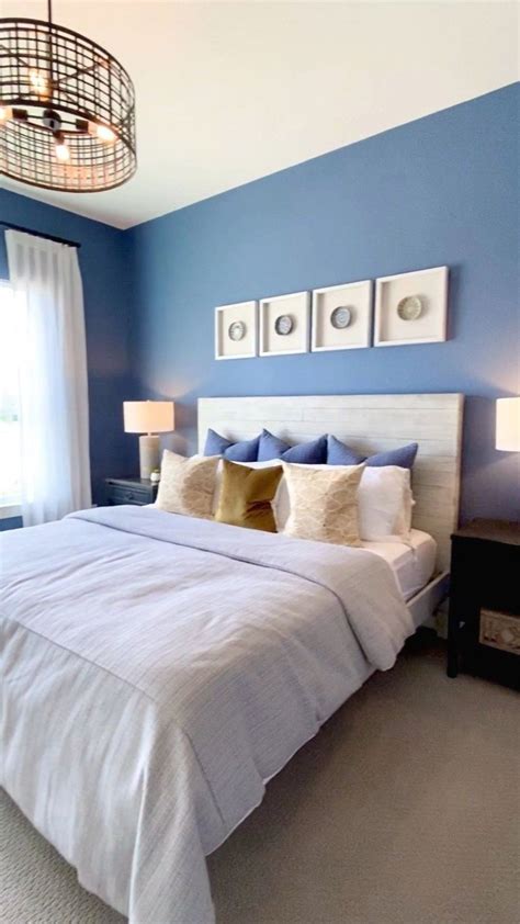 Guest Bedroom With Bold Blue Walls Light Bedding Industrial Chandelier