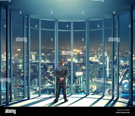 Businessman Is Standing In Front Of Night View Of Buildings From The