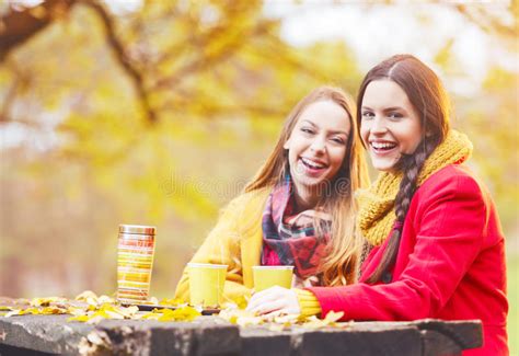Two Beautiful Young Women Talking And Enjoying On An Autumn Day Stock