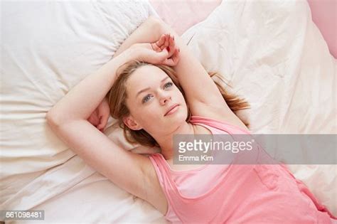 Girl Lying On Bed Gazing Upwards Photo Getty Images