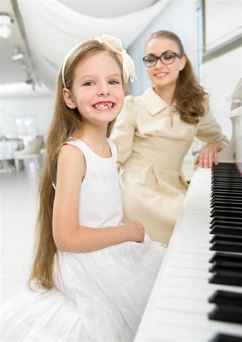 Music Tutor Teaches Little Girl To Play Piano Stock Photos Free