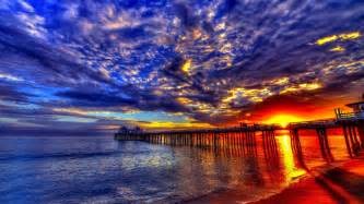 Sunset Beach Sea Pier Platform On Wooden Pillars Sky Clouds Evening