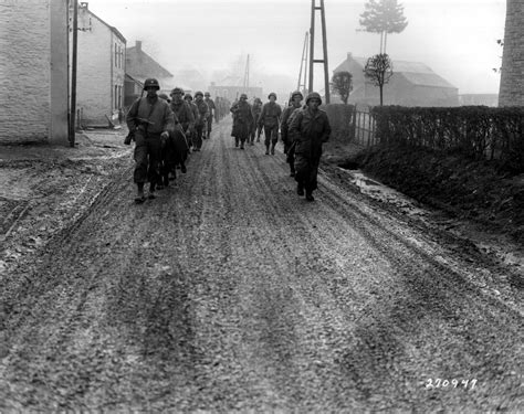 Photo Men Of Us 28th Infantry Division Marching Down A Street In