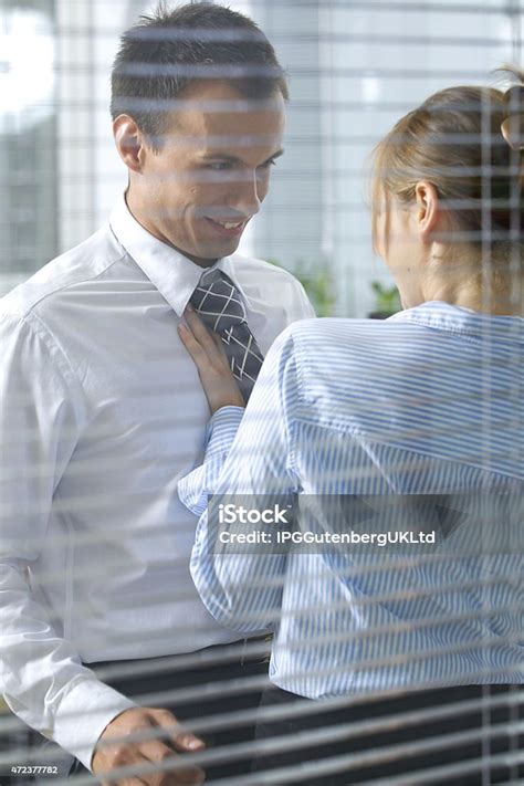 Businesswoman Flirting With His Colleague In Office Stock Photo