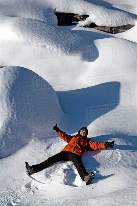 Person Making Snow Angels Stock Photo Dissolve