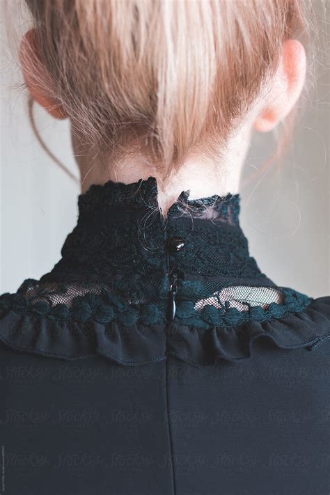 Ver Back View Of Girl With Blonde Hair Wearing A High Collared Black