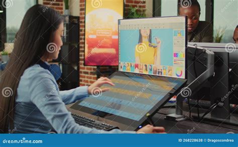 Female Colorist Editor Using Retouching Software With Tablet Stock