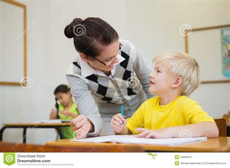 Pretty Teacher Helping Pupil In Classroom Stock Image Image Of Early
