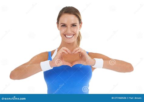 Shes Heart Smart Young Woman In Sportswear Making A Heart Shape While
