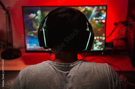 Stock Image Portrait From Back Of Teenage Gamer Boy Looking At Screen