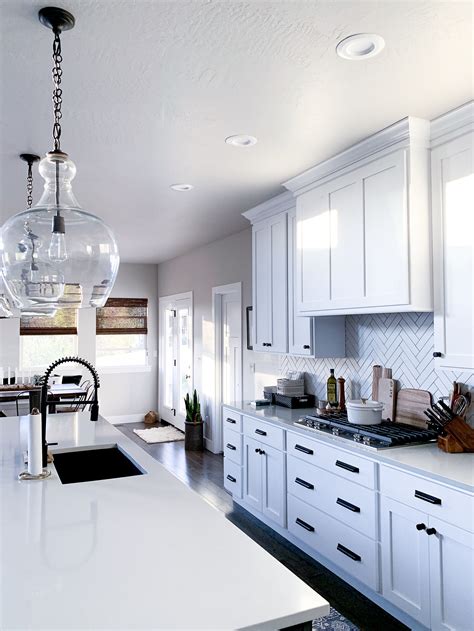 Use tall kitchen cabinets to frame a refrigerator or wall oven for a seamless look. We had to have these Pottery Barn Oversize Flynn Pendant Light for over our kitchen island. The ...