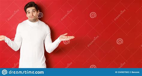 Portrait Of Clueless Handsome Guy Shrugging With Hands Spread Sideways