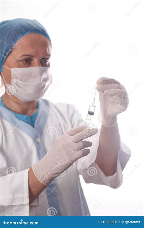 The Female Doctor Is Preparing The Syringe For Injecting Stock Image