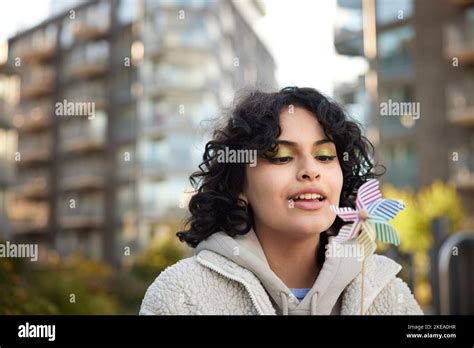 Teenage Girl Blowing On Pinwheel Stock Photo Alamy