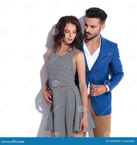 Casual Man Holds His Woman By Her Waist While Standing Behind Stock