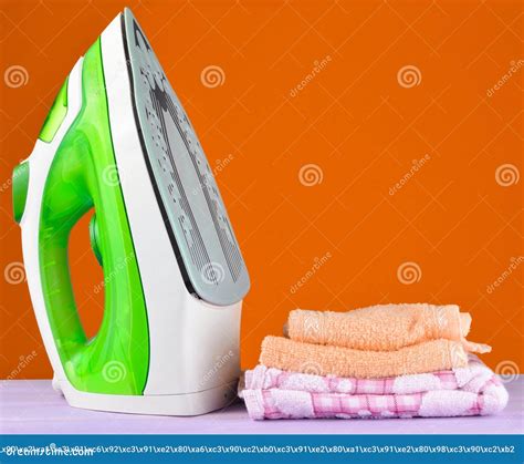 Pile Of Colorful Clothes And Irons On Pastel Wooden Plank Stock Image