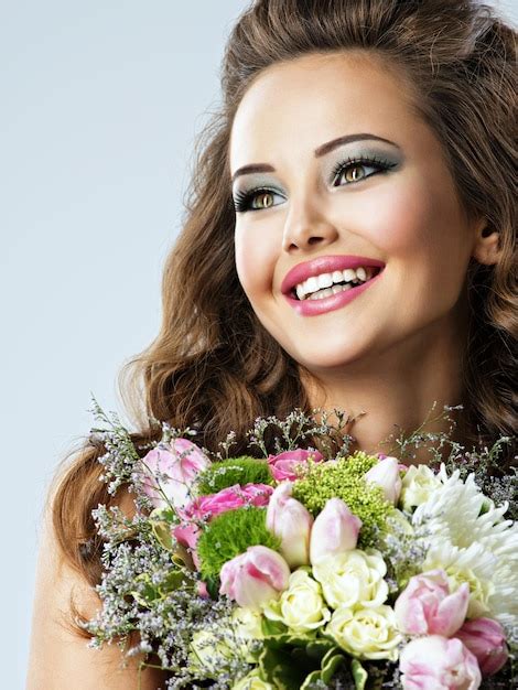 Free Photo Portrait Of Beautiful Happy Girl With Flowers In Hands