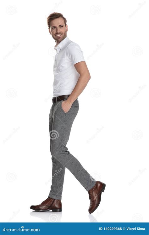 Man With Hands In Pockets Walking And Looking Back Stock Photo Image