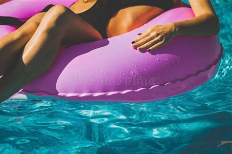 Summer Vacation Woman In Bikini On The Inflatable Donut Mattress In The Spa Swimming Pool