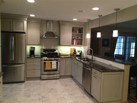Custom made light fixture by allison berger. Taupe cabinets with Cambria quartz countertops | Kitchen ...