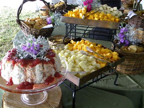 An Assortment Of Cheeses And Fruit On Display At A Buffet Table With