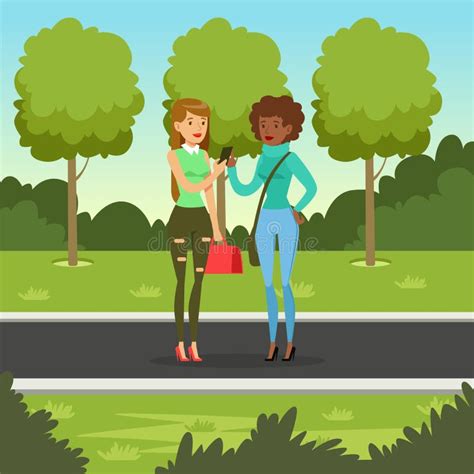 Two Girlfriends Talking While Walking In The Park Woman Showing