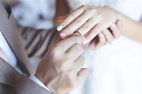 But why is the wedding ring worn on the ring finger in the first place? Close Up Groom Put The Wedding Ring On Bride Stock Photo ...