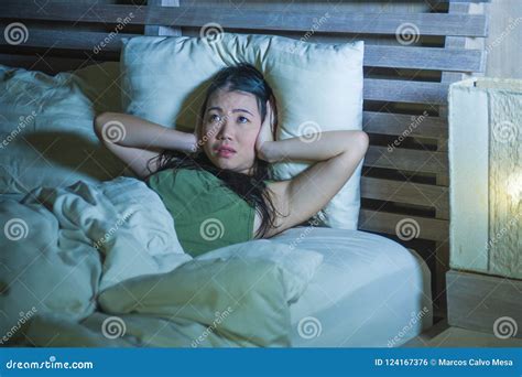 Young Beautiful And Stressed Asian Chinese Woman Having Insomnia Lying