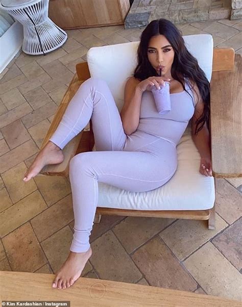 kim kardashian puts her famous curves on display in purple loungewear set while sipping a