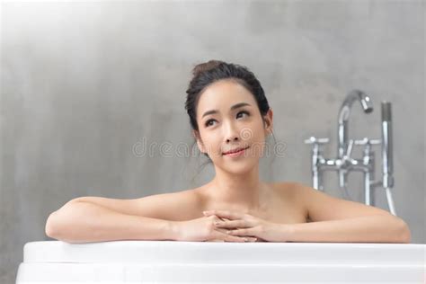 Smiling Beautiful Asian Girl Relaxing In The Tub At The Home Stock