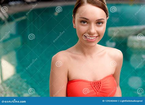 Beautiful Girl In Swimwear Smiling At Camera While Standing Near Pool