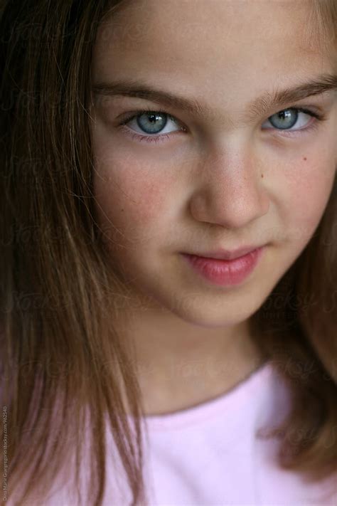 portrait of beautiful blue eyed girl wearing pink del colaborador de stocksy dina marie