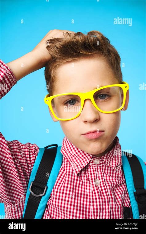 Schoolboy With Backpack Wearing Glasses Close Up Blue Background