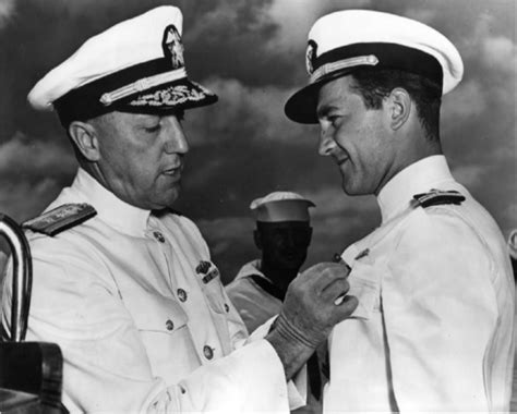 Rear Admiral Charles Lockwood Presents The Navy And Marine Corps Medal To John Bienia Of The