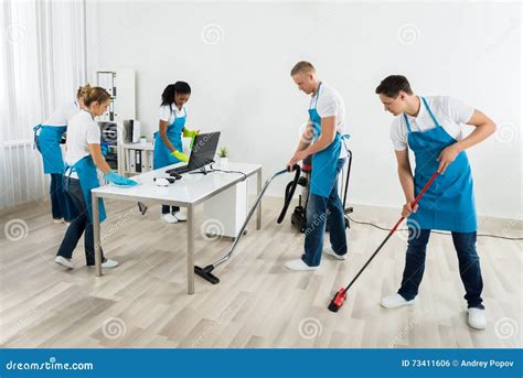 Group Of Janitors Cleaning The Office Stock Photo Image Of