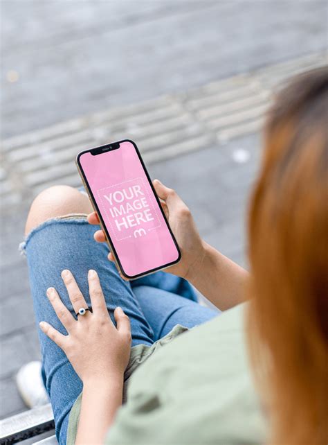 Iphone Mockup Featuring A Sitting Woman Holding It On Her Both Hand