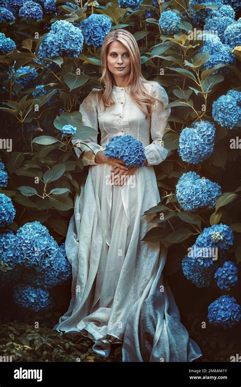 Beautiful Woman Among Hortensia Flowers Stock Photo Alamy