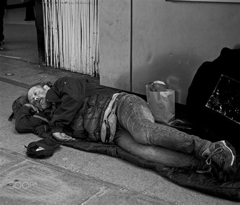 homeless in london homeless man sleeping on the pavement in london homeless man sleeping