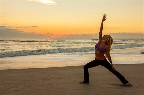 Woman Practicing Yoga On Beach At Sunrise Or Sunset Stock Image Image