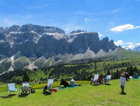 People Relaxing In The Mountains Near Refugio Restaurant In The Alps